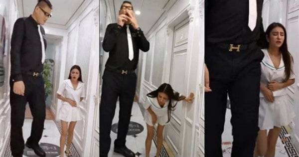 Bức ảnh gây tranh cãi MXH của chàng trai cao 2,38m và cô gái 1,6m ôm bụng đi ra từ khách sạn